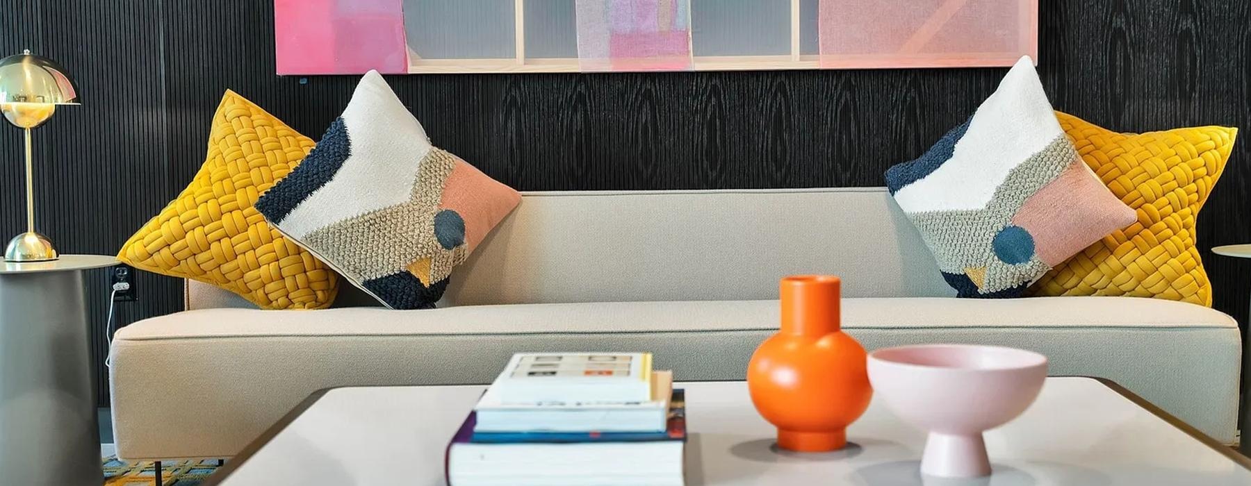 a couch with pillows and books